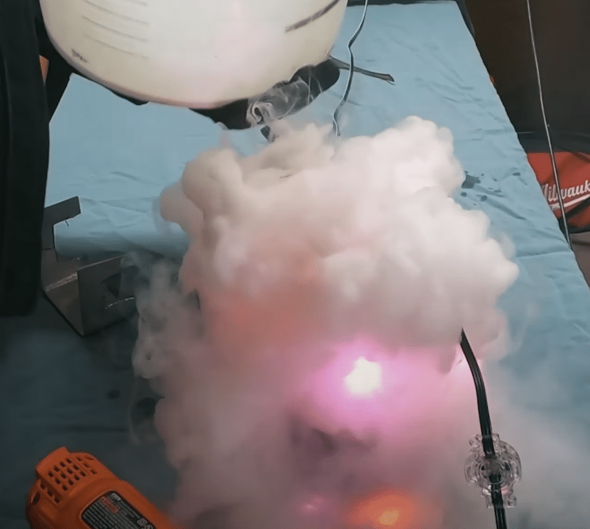 A pitcher with Watts Permanent Christmas Lights frozen in ice is topped with dry ice and water and billows out frozen water vapour while staying lit, demonstrating they're the best.